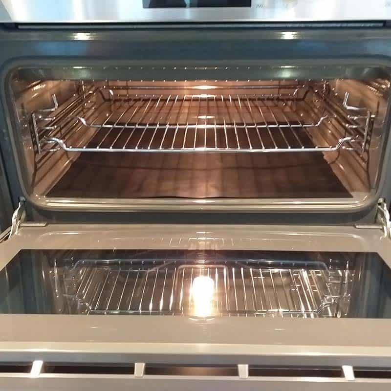 clean-oven-two clean single oven with light on and door open
